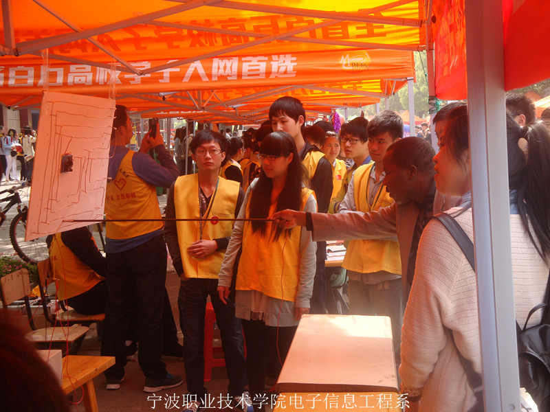 图为:外国友人在电子信息工程系电流迷宫展区玩游戏 图为:外国友人在电子信息工程系电流迷宫展区玩游戏